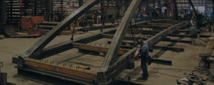 Workers fabricating a steel bridge in a Greiner facility