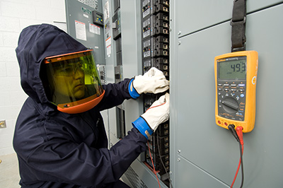 A member of Greiner's electrical contracting team performing maintenance and electrical services on site