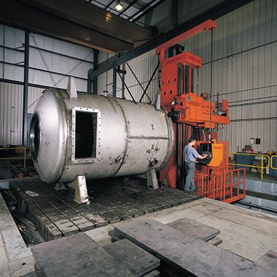 Worker fabricating a pressure vessel at a Greiner facility