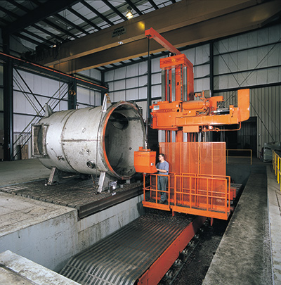 Worker operating a horizontal boring mill at a Greiner facility