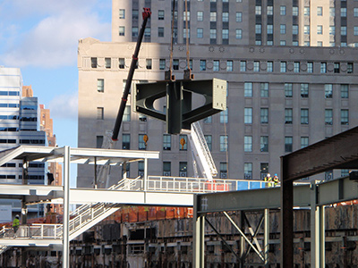 A crane placing a hammerhead column base plate at the world Trade Center's new Transportation Hub