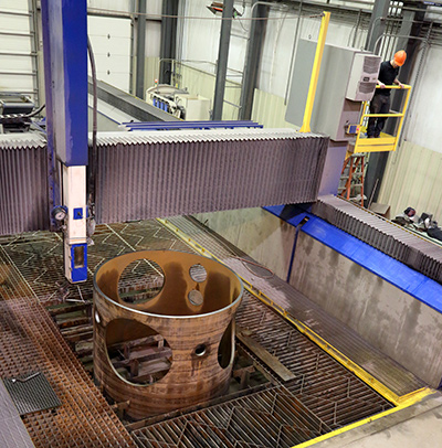 WaterJet cutting holes in a steel cylinder after rolling