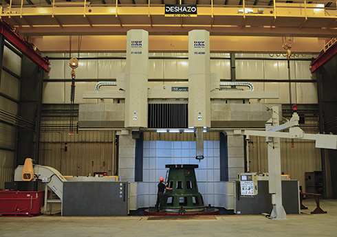 Worker operating a vertical turning center